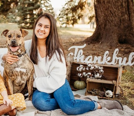 Ashley sitting with her dog